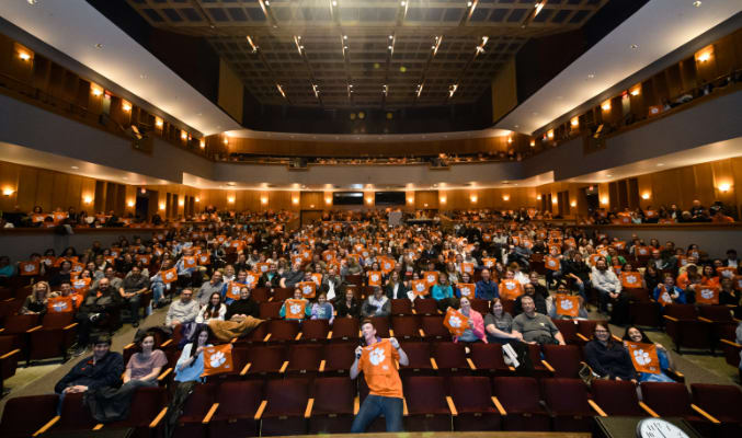 New Clemson students sit in Brooks Performing Arts Center at the beginning of an event.