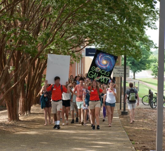 Orientation ambassadors lead their groups of students across campus during a Summer Orientation session.