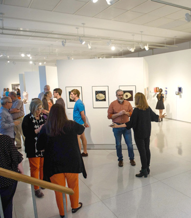 A group of students and faculty attend a gallery showing in Lee Hall