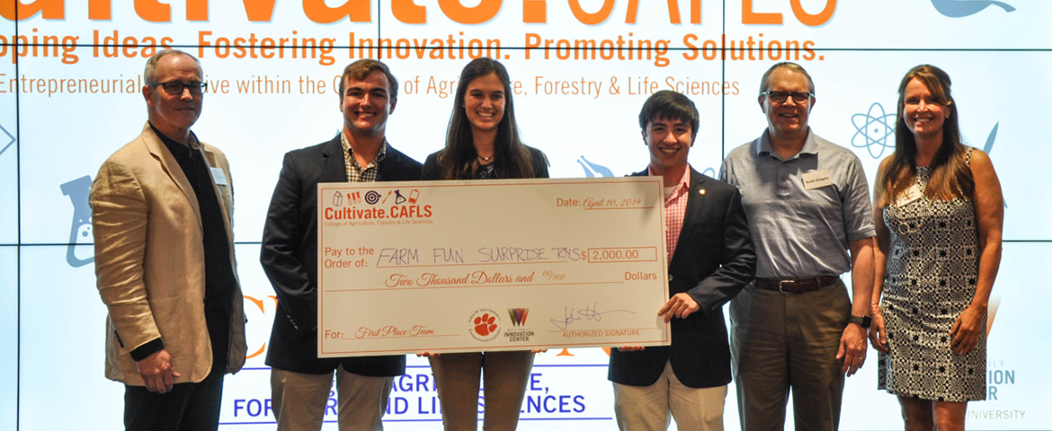Group photo of the 2019 winning  cafls cultivate team posing with a check