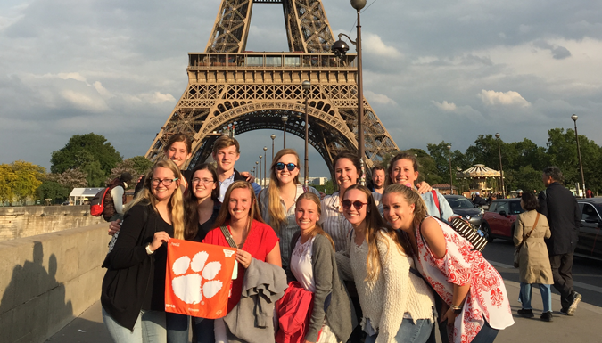 student group posing for a picture in front  of Eiffel tower