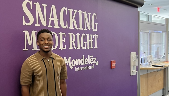 DeAundre Cooley in front of a Mondelez International asa Packaging RD sign