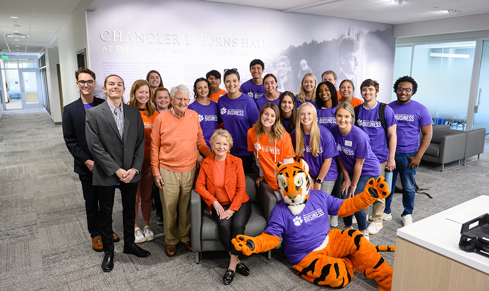Group of people standing together in office setting.