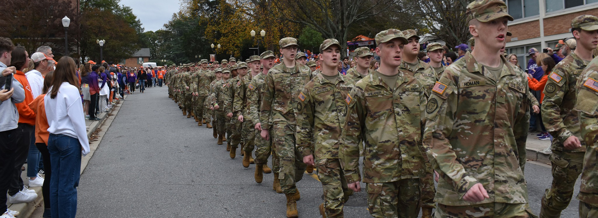 Cadets in camouflage marching on campus