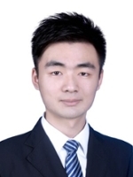 Professional headshot of a young man in a suit and tie.