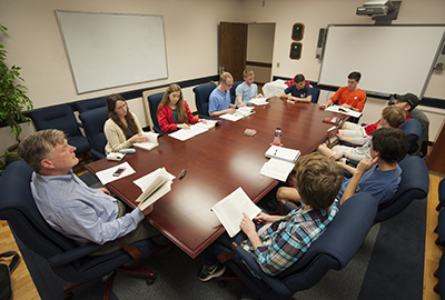 Teacher and Students sitting around a big table