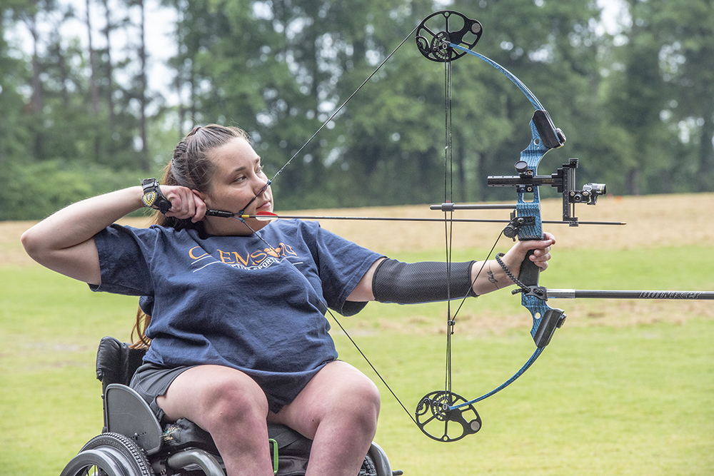 A woman in a wheelchair competing in adaptive archery at Clemson's Southeastern Regional Wheelchair Games