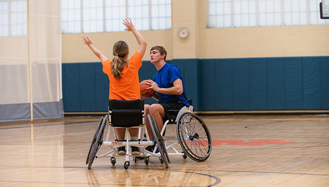 Two Clemson students playing wheelchair basketball.