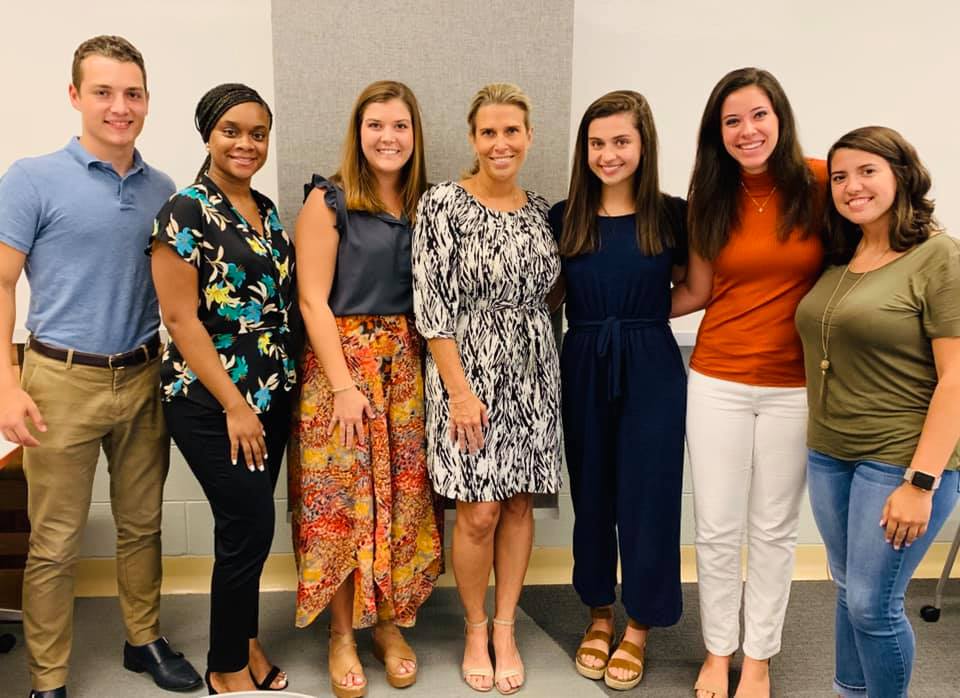 CEPA students standing with Sarah Moll ('99)