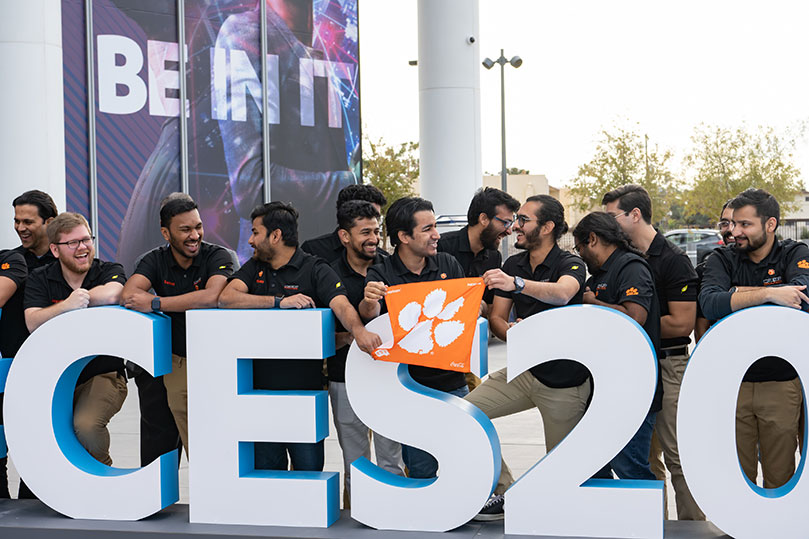 Group that went to the CES event, with orange tiger rag flag. 