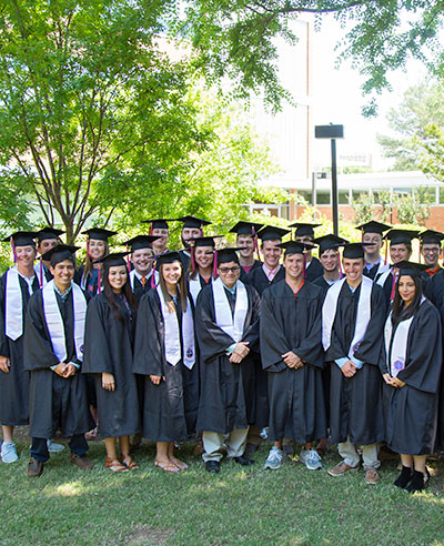 Group of graduates outside of Lowry Hall.