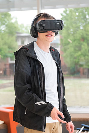 Male student using VR equipment.