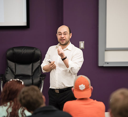 Amin Khademi teaching in front of students.