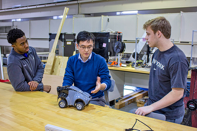 Students and faculty member work on autonomous technology.
