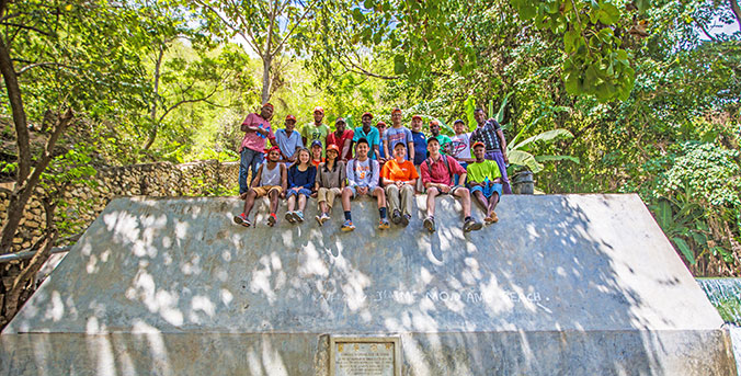Students gathered on wall during trip