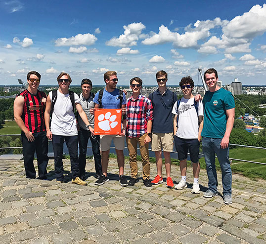 Group of students abroad with Clemson flag