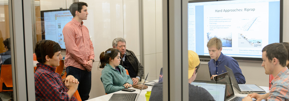 Students work on a project in a Watt Center breakout room.