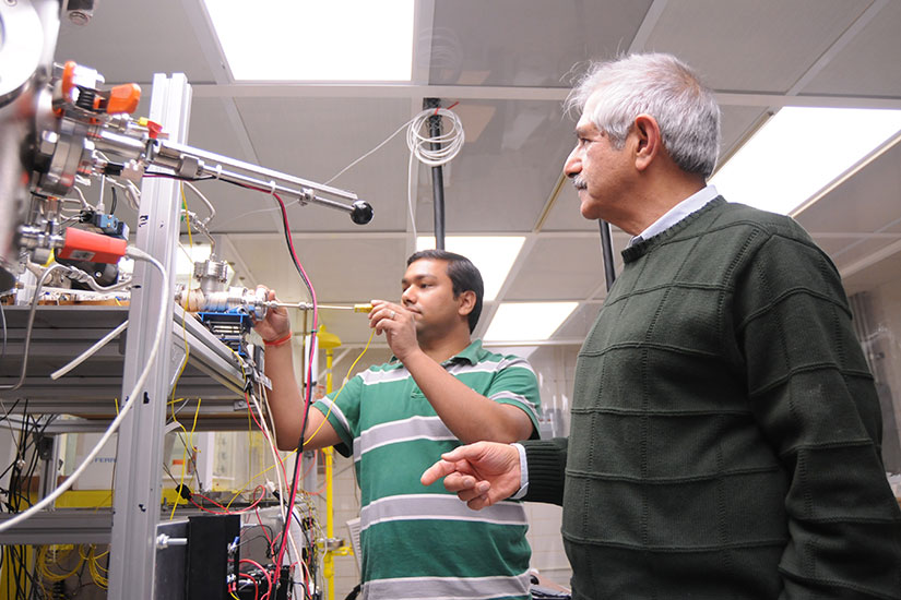 Singh with student in lab