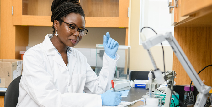 Female in lab utilizing equipment