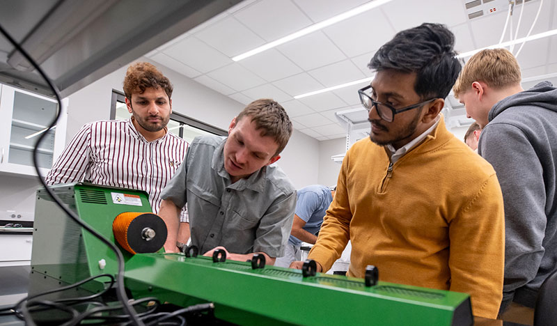 Students conduct experiments with 3D printing machines in the Bishop Family Teaching Lab under the supervision of Materials Science and Engineering lecturer Aniruddha M. Dive and assistant professor Dong Hou in Clemson's Advanced Materials Innovation Center