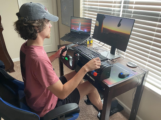 A student watching a flight simulation on a screen.