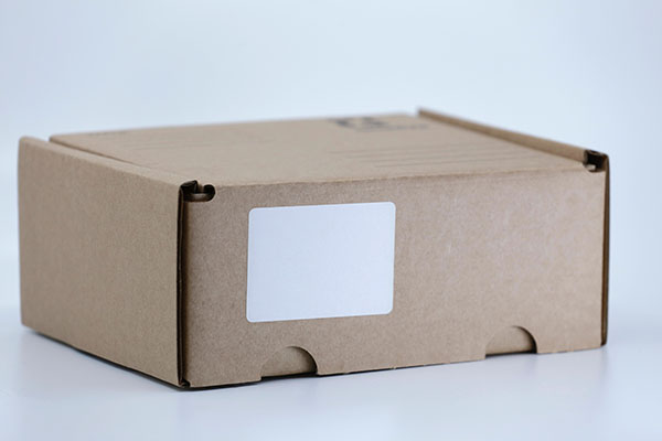 Cardboard box with blank shipping label.