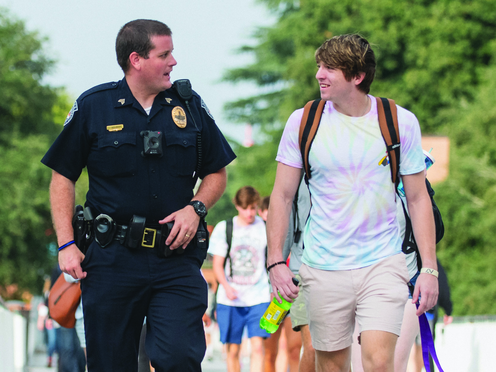 Image of Clemson UNiversity Police Department Officer walking with a Student