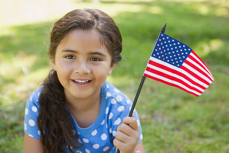 child holding a small US flag