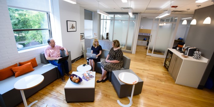 A group of three employees sitting and talking