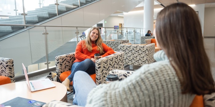 Two people having a friendly discussion while enjoying coffee