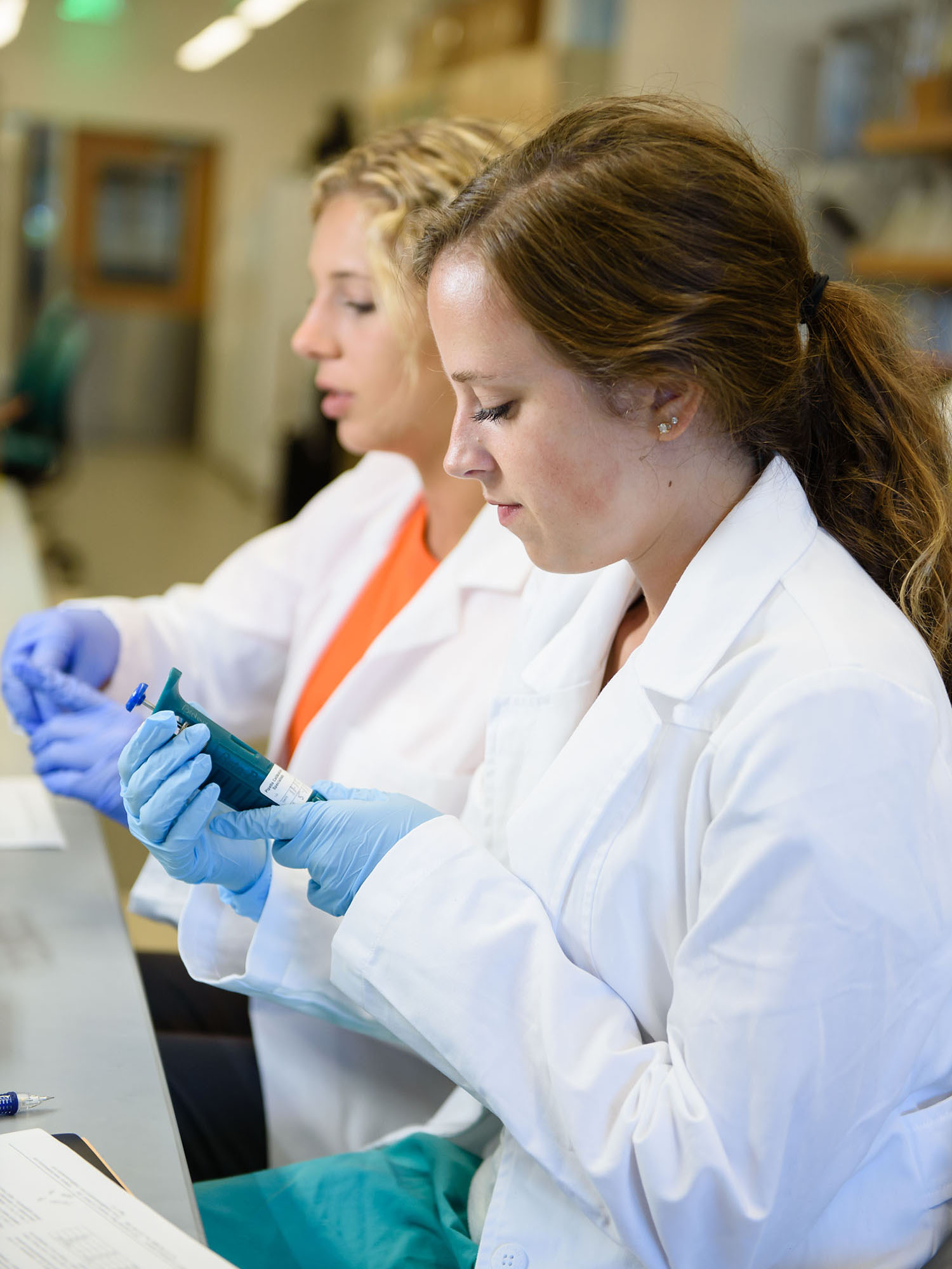 Two female students working in lab.