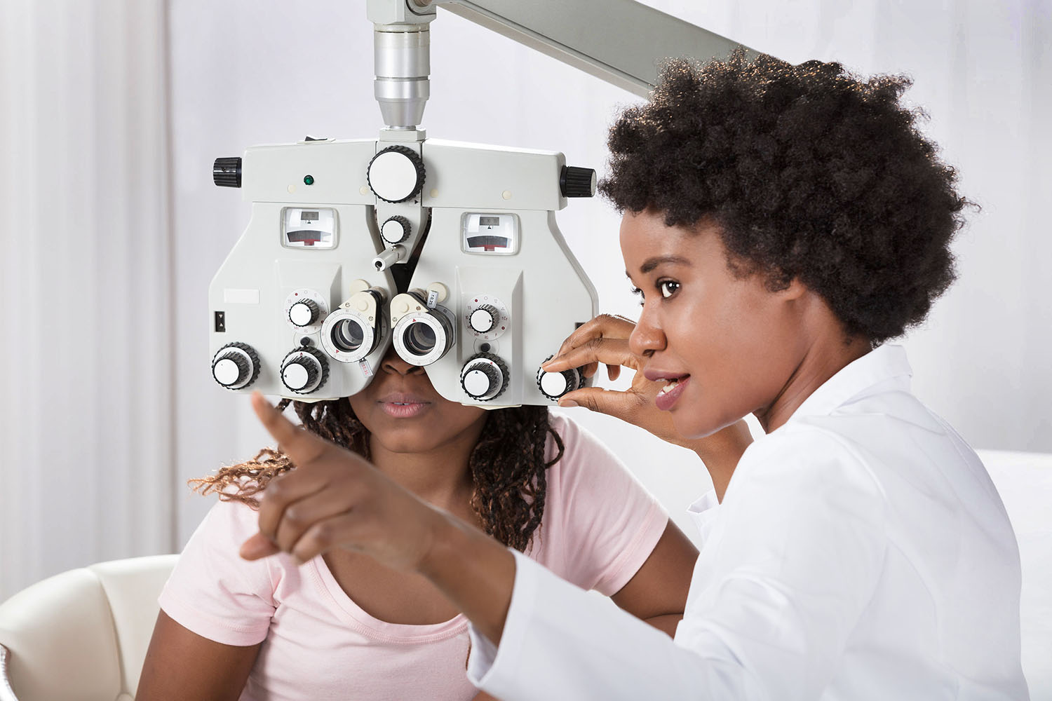 Optometrist examining patient's eyes.