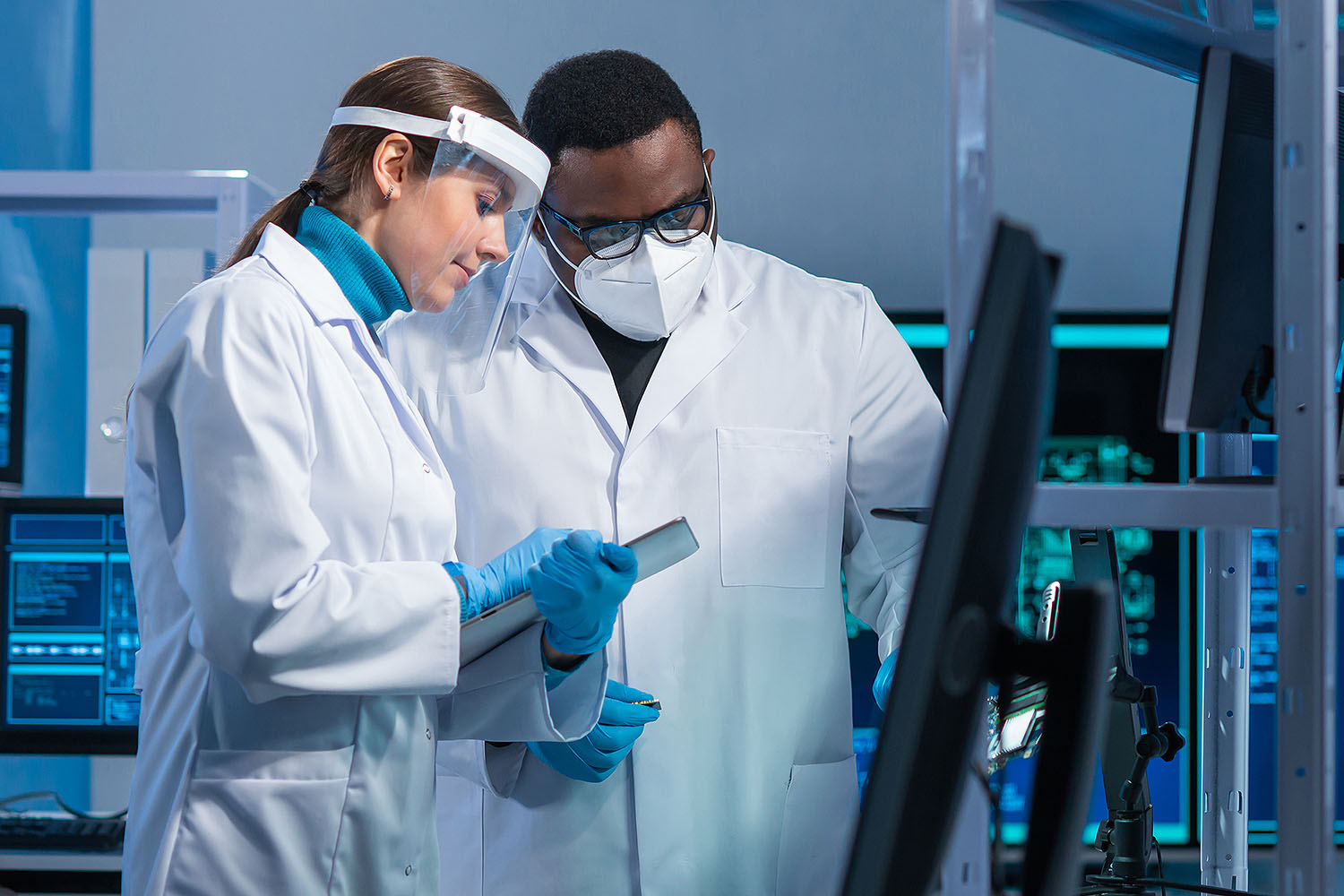 Woman and man in lab studying charts.