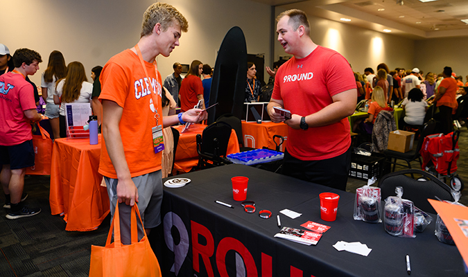 Clemson student interacting with 9 Rounds Staff