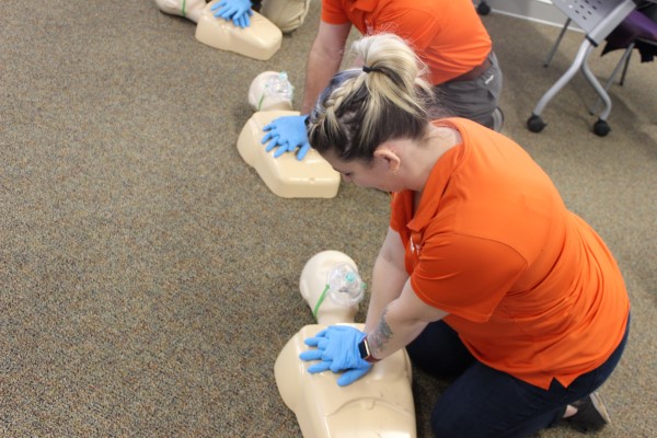 woman practicing CPR on a manikin