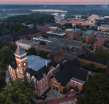 Clemson's campus from above shows Tillman Hall, Death Valley and Lake Hartwell on a foggy morning.