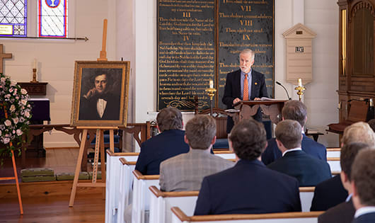 Clemson Provost Bob Jones addresses men and women gathered in a church on the anniversary of Clemson's founder's death.