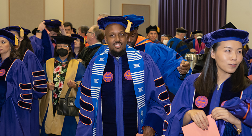 Students in their doctoral regalia as they prepare for the hooding ceremony.