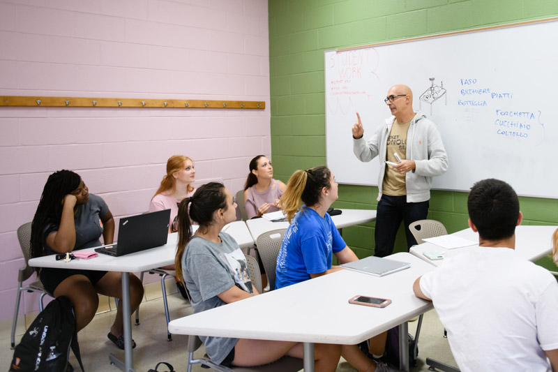 A Professor gives an Italian lecture to a small class in Daniel Hall