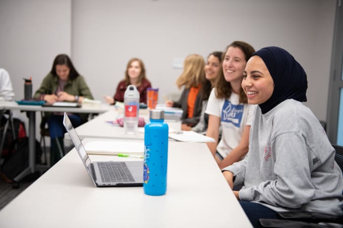 Honors college students sit together at a table during a seminar.