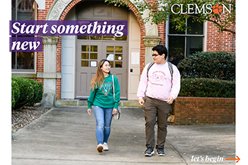 Two students chatting with eachother as they are exiting a building on campus.