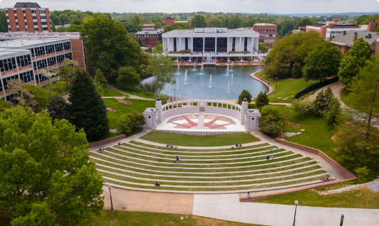 An aerial shot shows the ampitheater, reflection pond and Cooper Library.