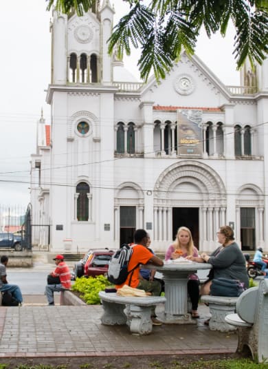 Clemson students sit a table in an international city while studying abroad.