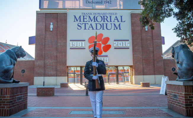 A member of Pershing Rifles stands in front of Memorial Stadium.
