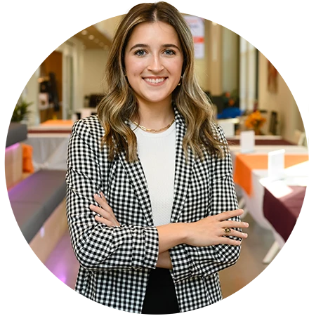 A female student in a houndstooth blazer poses in the Brook T. Smith Launchpad