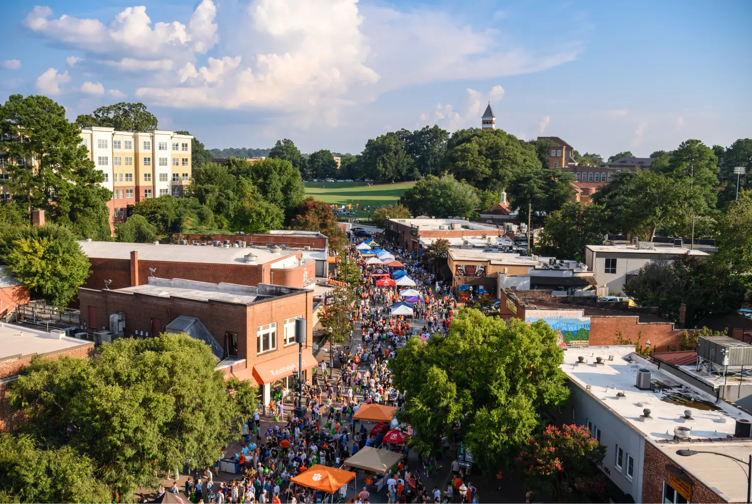 An aerial view of downtown Clemson packed with students during the welcome back festival, with bowman feild visible in the background