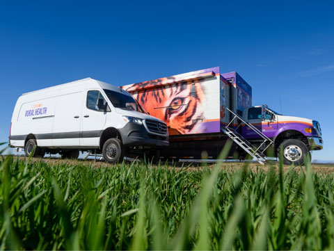 The Clemson Rural Health mobile clinics parked side by side.