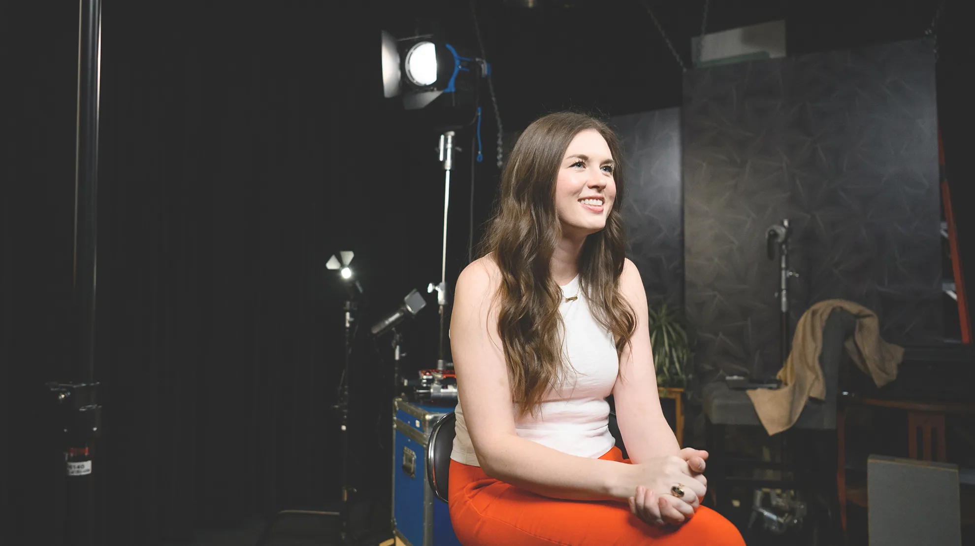 Caitlin Kickham sits in a backstage video area speaking to the camera.