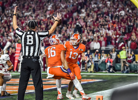 Hunter Renfrow is celebrating with a teammate in the endzone after scoring a touchdown for the Clemson Tigers.