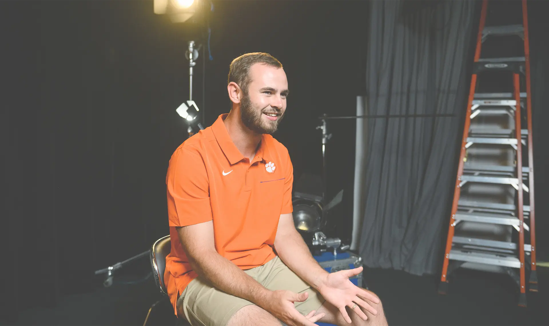 Hunter Renfrow sits in a backstage video area speaking to the Camera.
